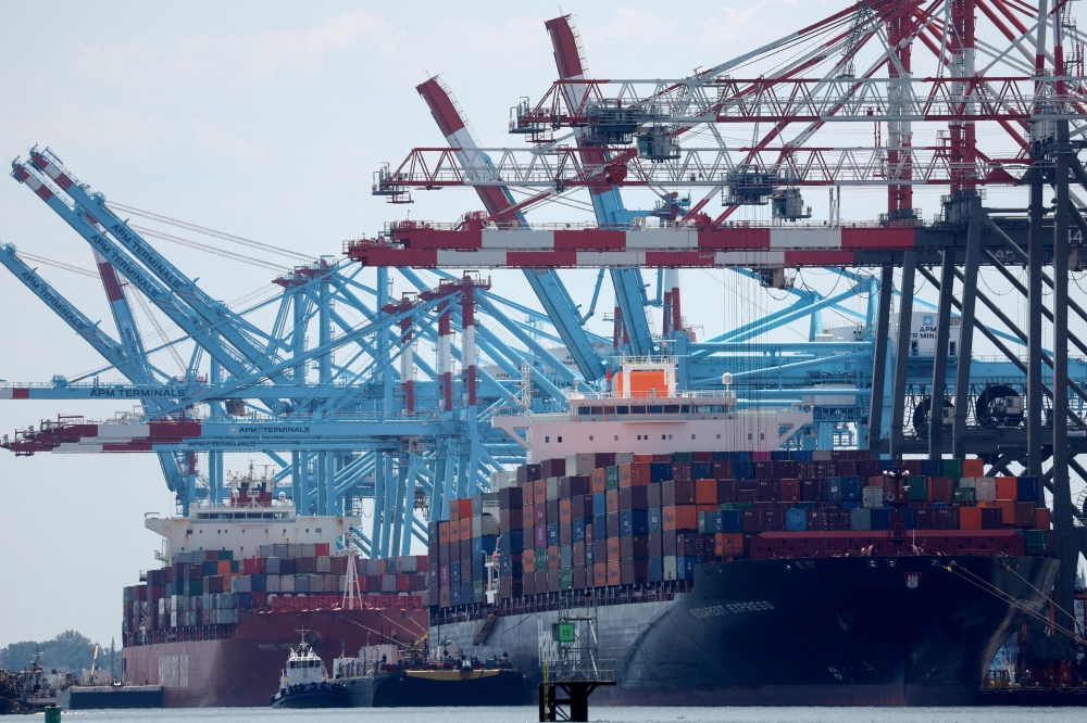 Docked cargo ships are loaded with shipping containers at Port Elizabeth, New Jersey July 12, 2023. Trump has promised at least a 10 per cent tariff on all imports, and a higher level of 60 per cent or more on Chinese goods — stepping up levies on Beijing and others. — Reuters pic