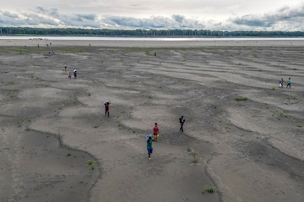  Aerial view of Yagua Indigenous people carrying water and other goods due to the low level of the Amazon river at Isla de los Micos, Amazonas department, Colombia, on October 4, 2024. — AFP pic