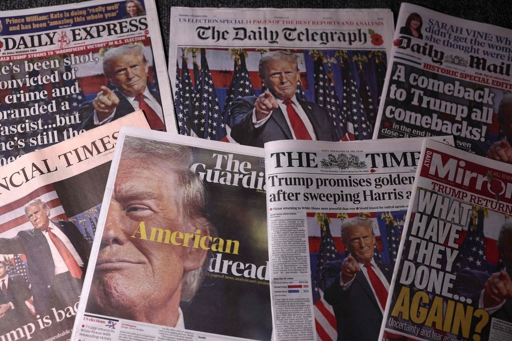 A picture taken in London on November 7, 2024 shows the frontpages of some of Britain's national newspapers about the re-election of US President-elect Donald Trump. — AFP pic