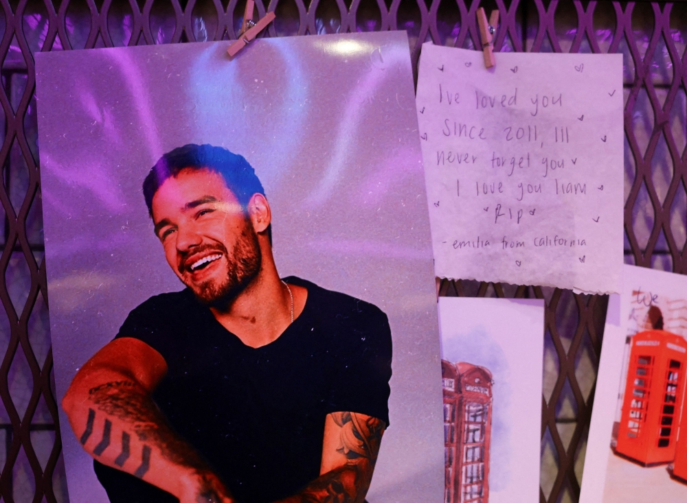 Tributes to Liam Payne, a former One Direction band member, seen at the Hard Rock Cafe in Piccadilly Circus, in London, Britain. — Reuters pic