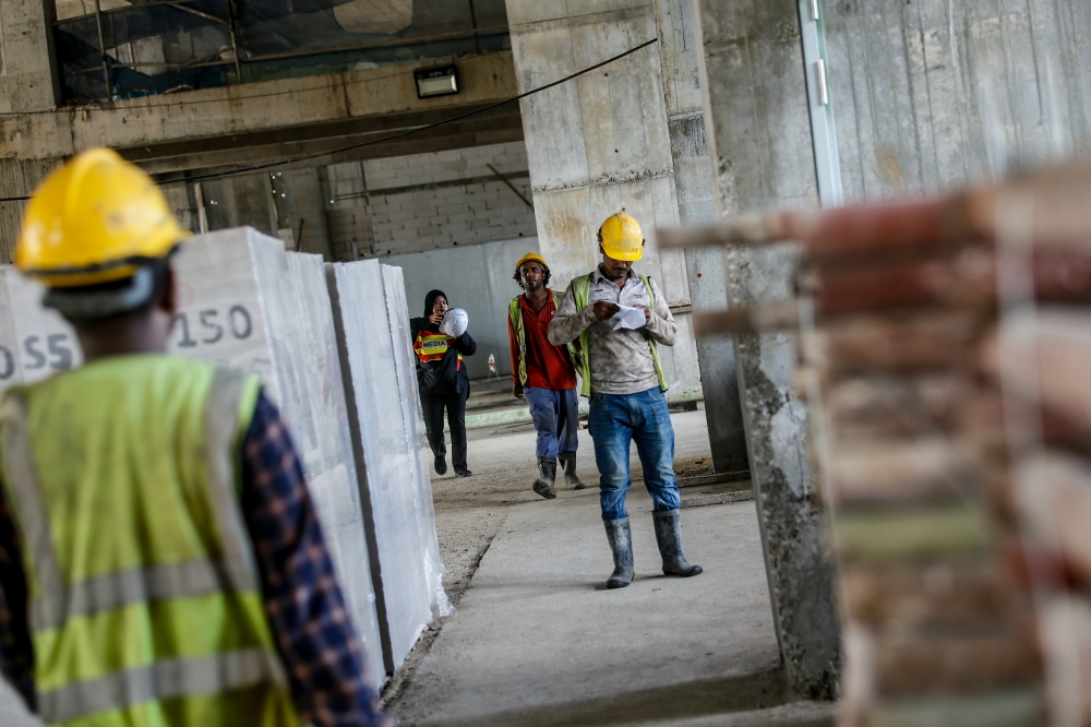 File photo of construction workers in Kuala Lumpur, May 16, 2024. A part-timer in Kuala Terengganu dies after materials in a trolley fell on him. - Picture by Hari Anggara.