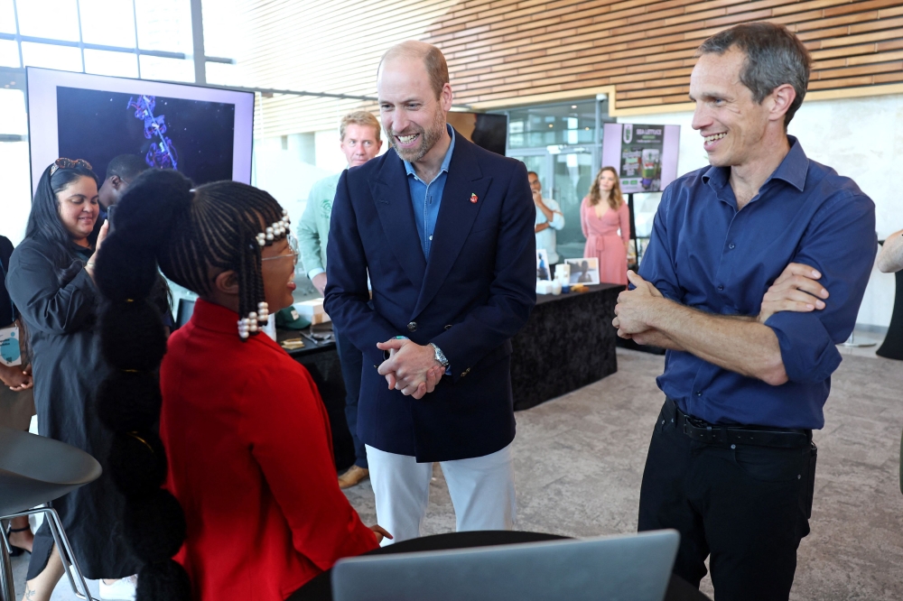 Prince William laughs with business representatives during a visit to meet seaweed businesses from the region to celebrate local innovation and to learn about the potential for it to repair and regenerate the planet in Cape Town November 7, 2024. — Reuters pic