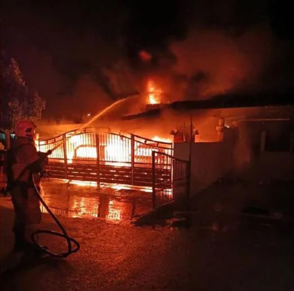 Perak police have detained a Vietnamese woman to assist with an arson investigation involving three homes and four vehicles in Taman Singa, near Sitiawan, early yesterday. — Picture courtesy of the Fire and Rescue Department 