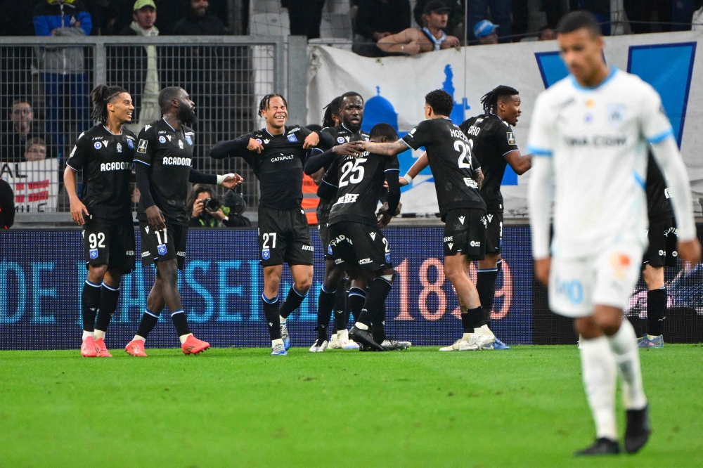 Auxerre's players celebrate their third goal during the French L1 football match between Olympique de Marseille and AJ Auxerre at Stade Velodrome. — AFP