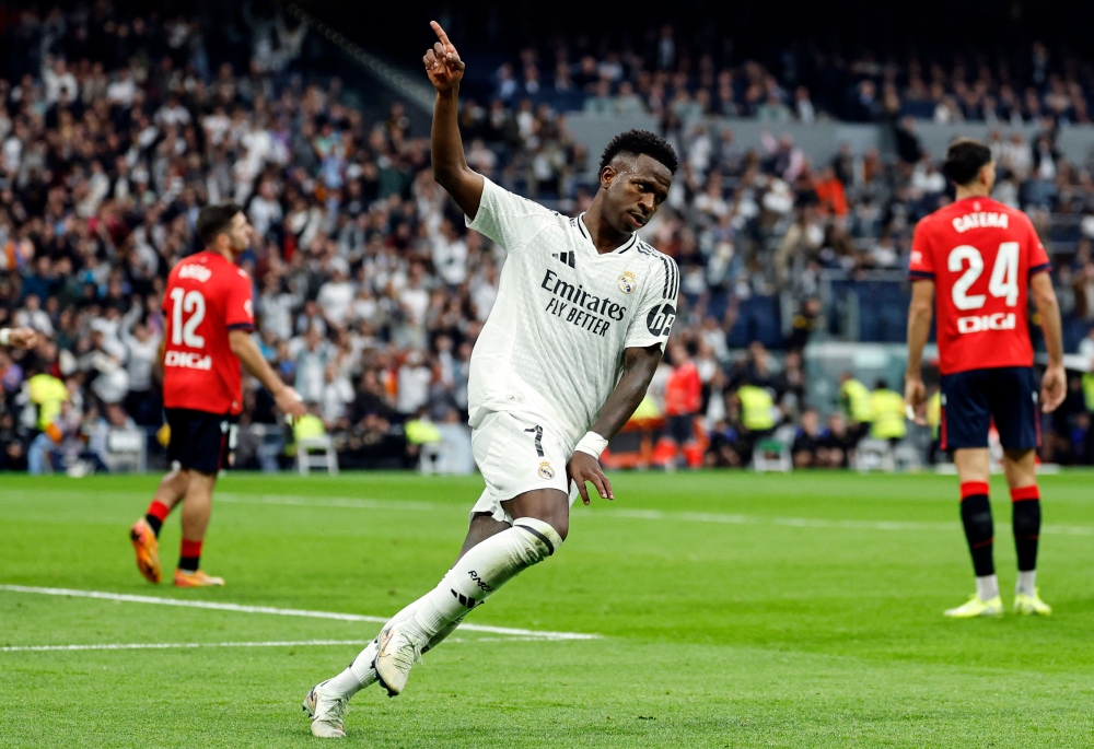 Vinicius Junior scored a hat-trick to help Real Madrid bounce back from two consecutive home defeats with a 4-0 win over Osasuna in La Liga on Saturday. — AFP pic