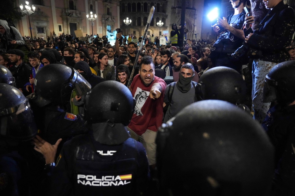 Tens of thousands of people marched yesterday in Valencia to voice their anger at the authorities’ handling of deadly floods. — AFP pic