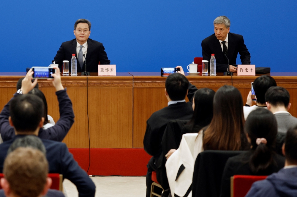 Chinese Finance Minister Lan Foan and Xu Hongcai, vice chairman of the financial and economic affairs committee of the National People's Congress (NPC), arrive for a press conference about a bill on raising ceilings on local government debt, at the Great Hall of the People in Beijing November 8, 2024. — Reuters pic  