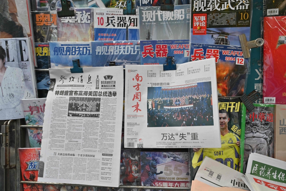 The front pages of newspapers in Beijing on November 7, 2024, show the reaction to the re-election of US President-elect Donald Trump. — AFP pic