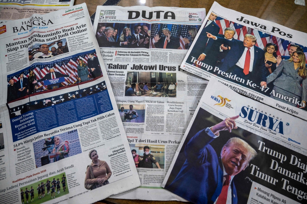 The front pages of the morning newspapers in Surabaya on November 7, 2024, show the reaction to the re-election of US President-elect Donald Trump. — AFP pic