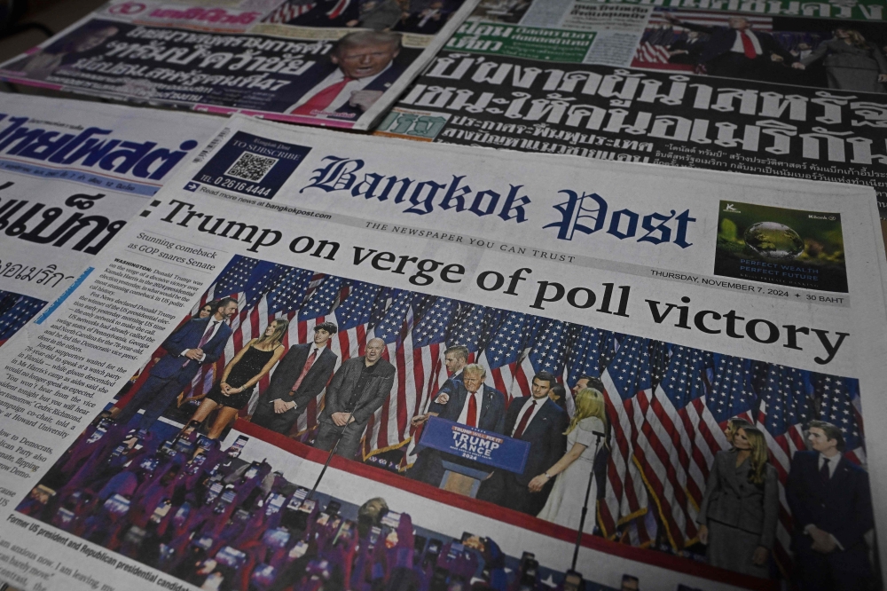 This photo illustration shows the front pages of the morning newspapers in Bangkok on November 7, 2024 showing the reaction to the re-election of US President-elect Donald Trump. — AFP pic