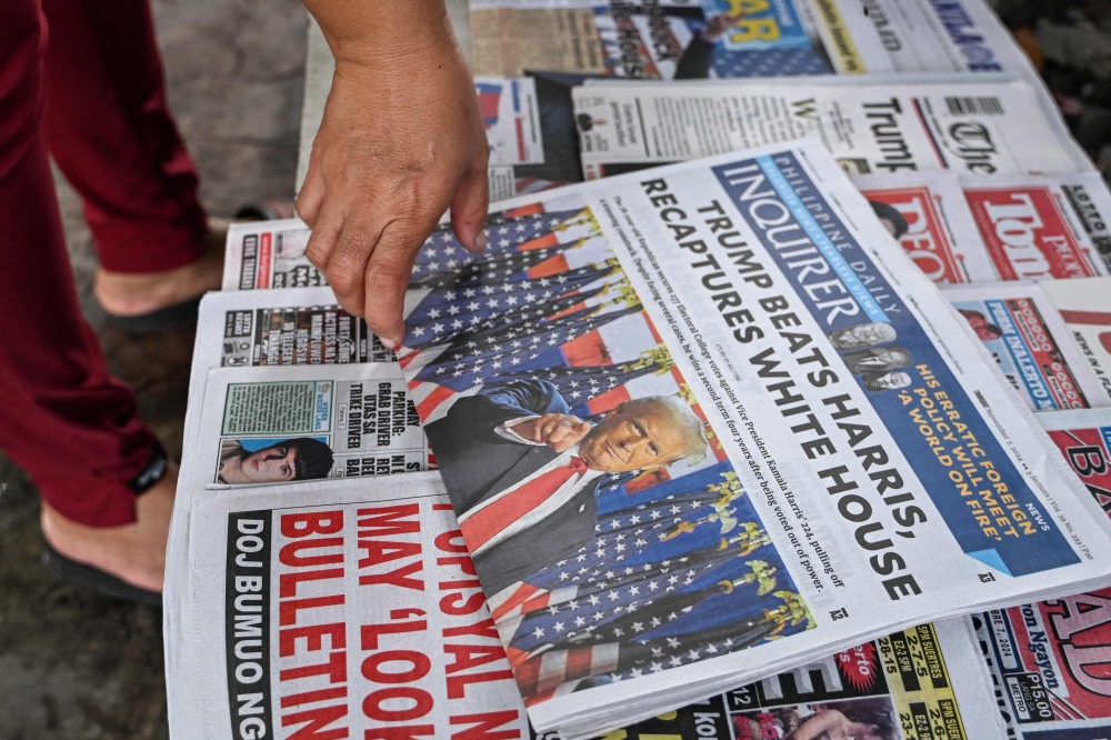 This photo illustration shows the front pages of the newspapers in Manila on November 7, 2024 showing the re-election of US President-elect Donald Trump. — AFP pic