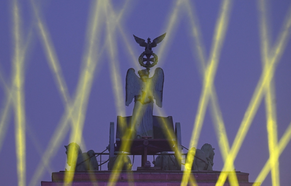 The quadriga on top the Brandenburg gate is illuminated during celebrations marking the 35th anniversary of the fall of the Berlin Wall in Berlin on November 9, 2024. — AFP pic