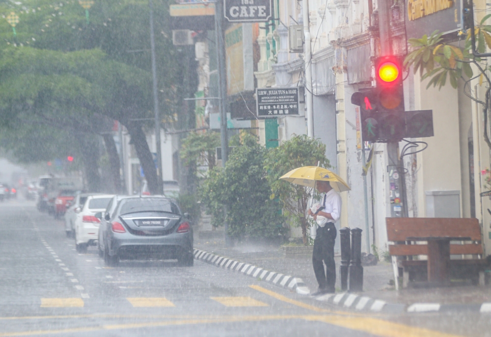 Thunderstorms, heavy rain, and strong winds are expected to affect eight states until noon today, according to the Malaysian Meteorological Department. — Picture by Farhan Najib