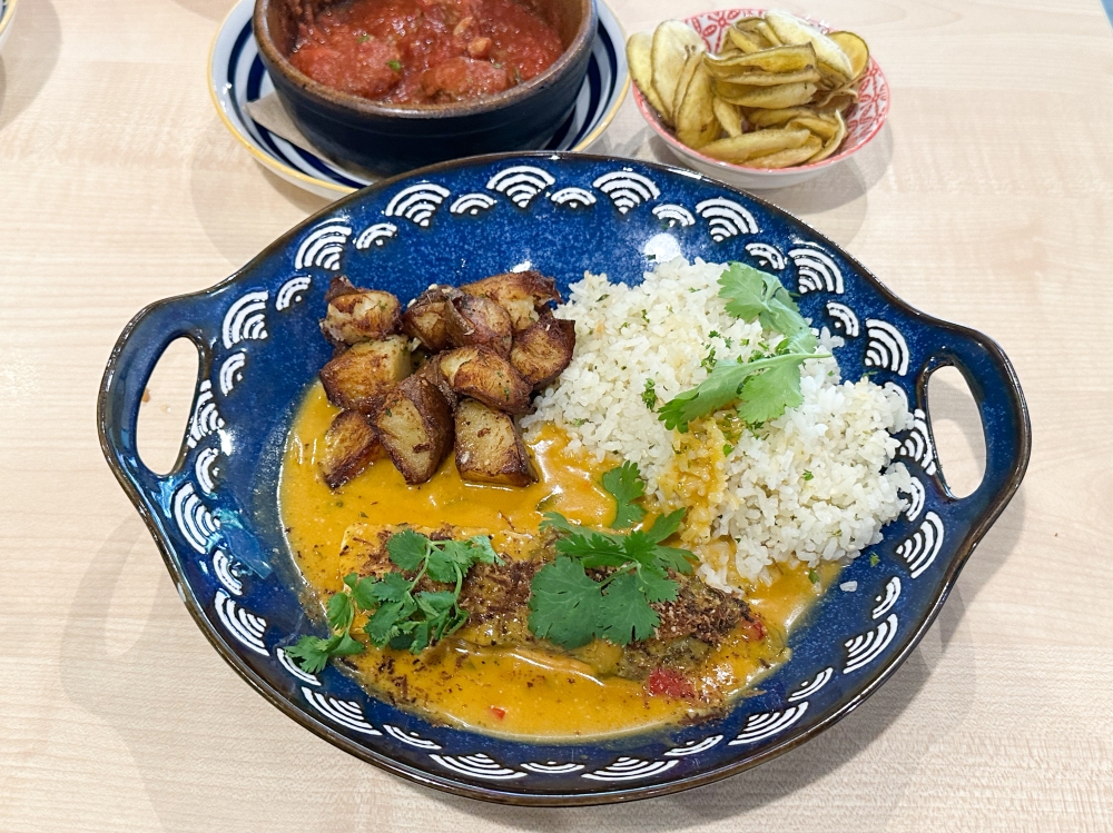 Salmon Moqueca, a Brazilian dish is perfect for a solo diner with its salmon served with a creamy coconut stew, cubes of garlic herbed potatoes and fluffy cilantro lime rice. — Picture by Lee Khang Yi