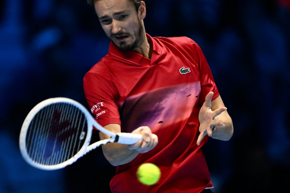 Russia's Daniil Medvedev hits a return to Australia's Alex De Minaur during their match at the ATP Finals tennis tournament in Turin on November 12, 2024. — AFP pic