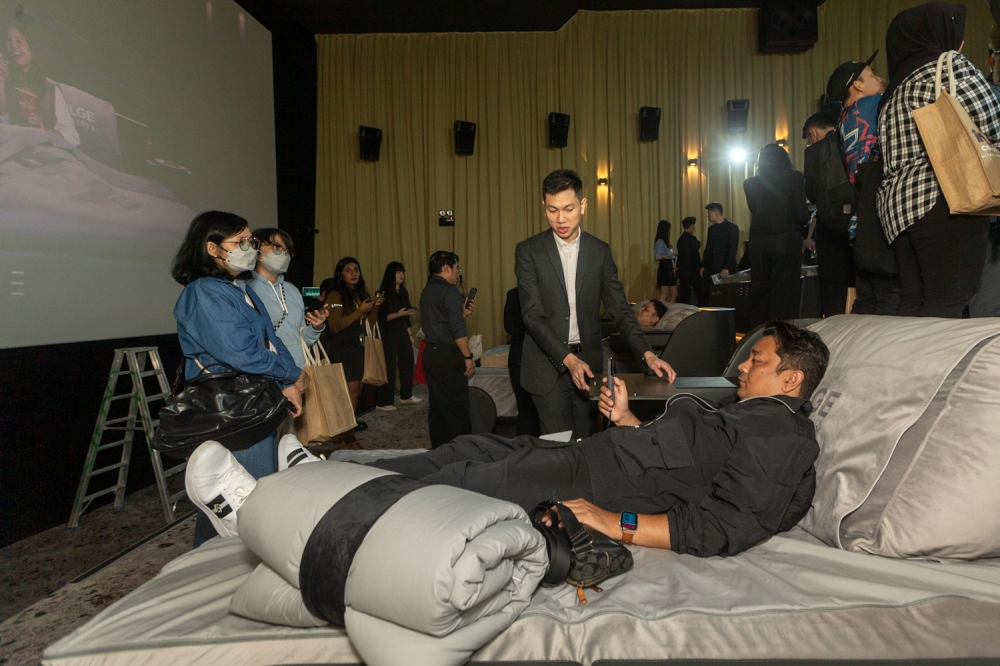 Members of the media try the bed seats after the TGV Indulge Coway Berex launch. — Picture by Raymond Manuel