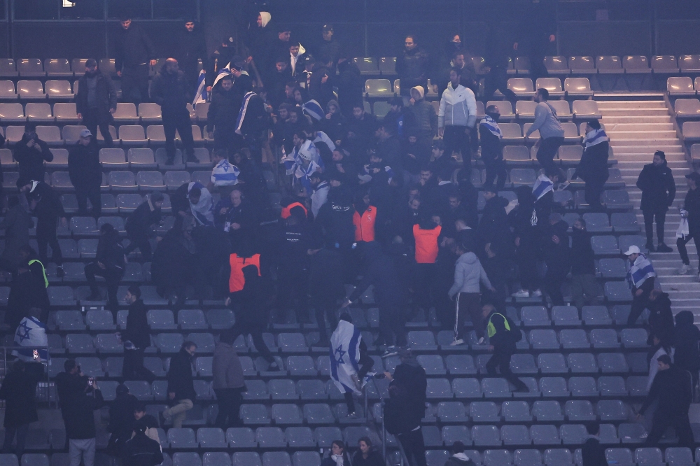 Stadium security intervene next to supporters holding Israeli flags during the UEFA Nations League League A, Group A2 football match between France and Israel at The Stade de France stadium in Saint-Denis, in the northern outskirts of Paris, on November 14, 2024. — AFP pic