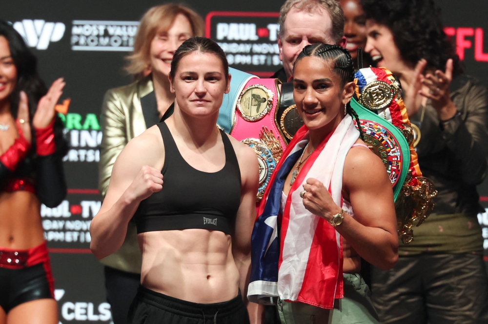 Katie Taylor (left) faces off with Amanda Serrano (right) after weighing in at the Toyota Music Factory.  — Reuters pic