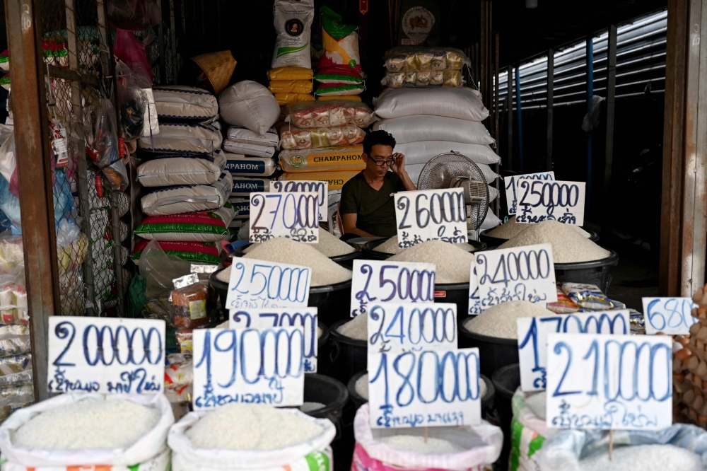 A rice vendor waits for customers at his shop in Laos’ capital Vientiane on October 8, 2024 as rampant inflation raises food prices, forcing a growing number of households to turn to foraging. — AFP pic