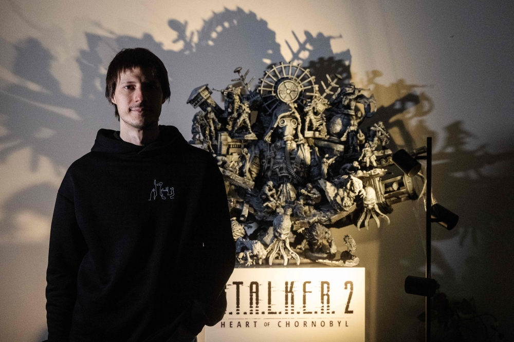 GSC Game World chief executive Ievgen Grygorovych poses for a photo in front of a sculpture statue representing the S.T.A.L.K.E.R. 2 video game on  November 8, 2024 in Prague. — AFP pic