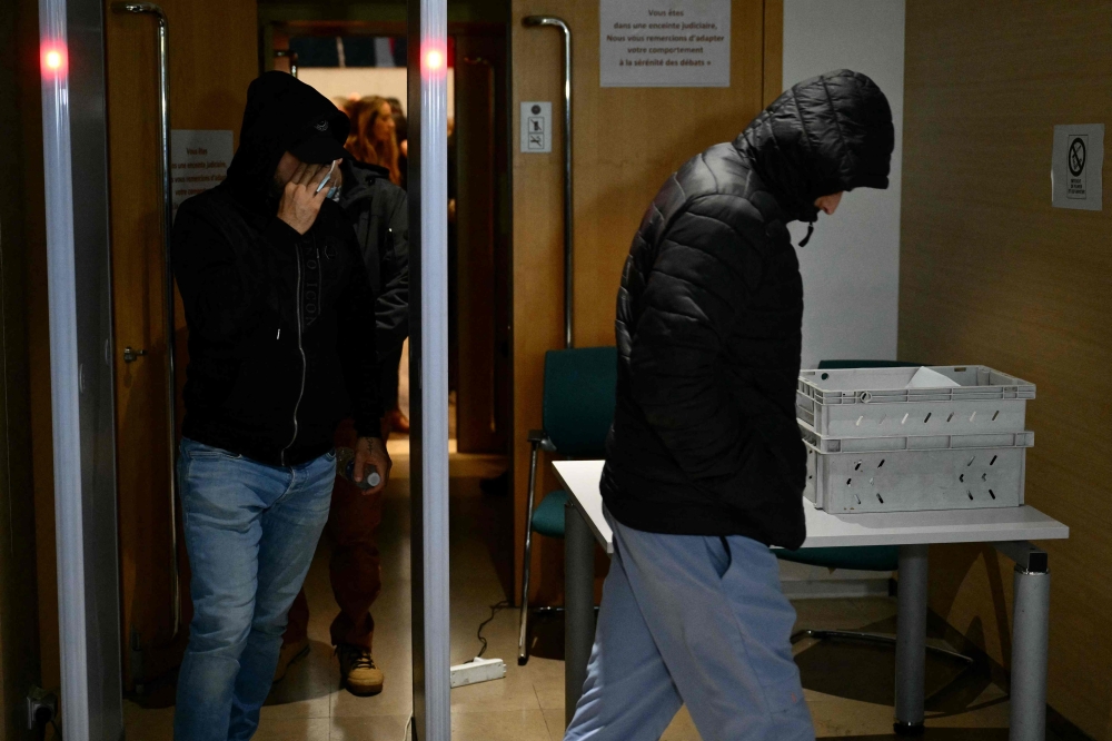 Co-defendants leave the courthouse after a hearing in the trial of Dominique Pelicot accused of drugging his wife for nearly ten years and inviting strangers to rape her at their home in Mazan, a small town in the south of France, in Avignon, on November 18, 2024. — Reuters pic  