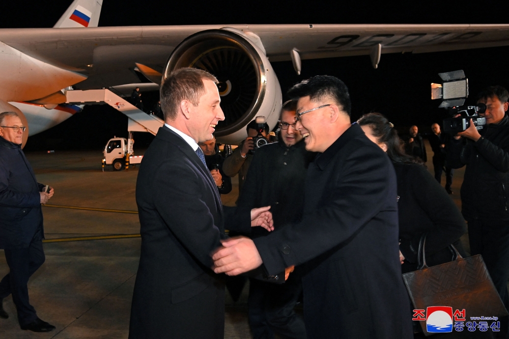 This picture taken on November 17, 2024 and released from North Korea’s official Korean Central News Agency (KCNA) via KNS on November 18, 2024 shows Russia’s Minister of Natural Resources and Ecology Alexander Kozlov (left) being welcomed upon his arrival at Pyongyang International Airport. — KCNA pic via KNS/AFP