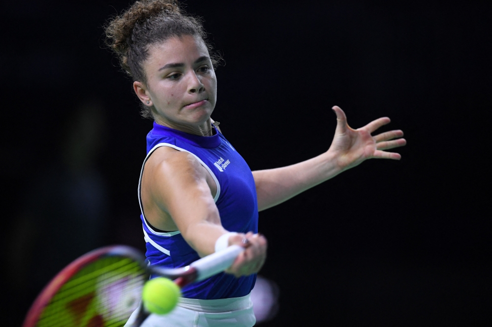 Italy's Jasmine Paolini returns a ball to Poland's Iga Swiatek during their semi-finals singles tennis match between Poland and Italy at the Billie Jean King Cup Finals at the Palacio de Deportes Jose Maria Martin Carpena arena in Malaga, southern Spain November 18, 2024. — AFP pic