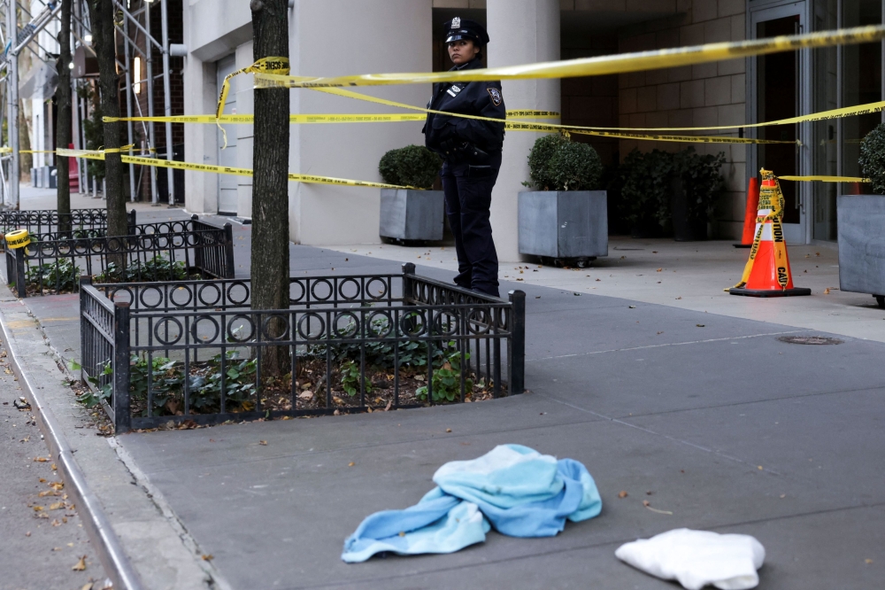 A police woman stands guard in the aftermath of a stabbing crime scene at 444 West 19th Street in New York City, New York November 18, 2024. — Reuters pic  