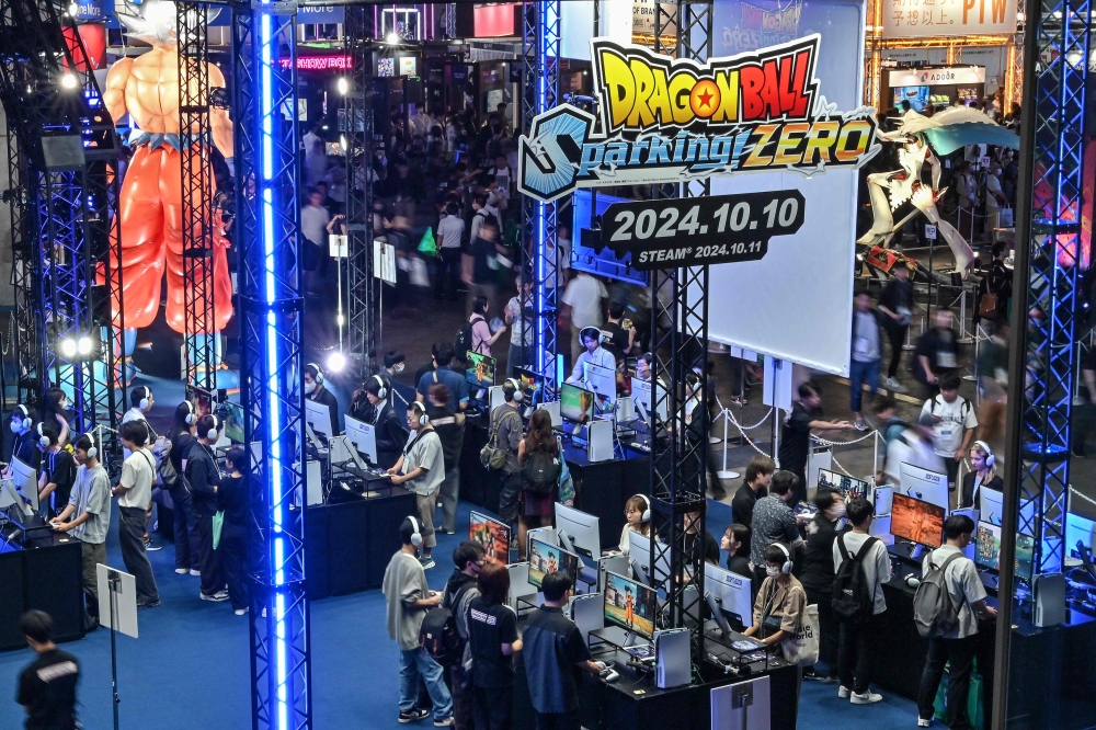 Visitors try out the latest ‘Dragon Ball’ game during the preview day for the annual Tokyo Game Show at Makuhari Messe in Chiba City, Chiba Prefecture September 26, 2024. — AFP pic