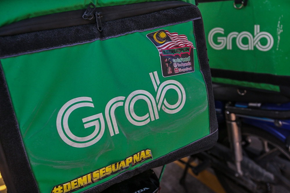 Besides e-hailing, Grab also offers food delivery and financial services. — Picture by Farhan Najib