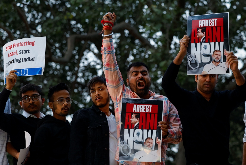 Supporters of India's main opposition Congress party hold placards during a protest against Indian billionaire Gautam Adani, after he was indicted in New York over his role in an alleged multibillion-dollar bribery and fraud scheme, in New Delhi, India, November 21, 2024. — Reuters pic