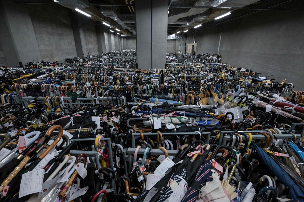 Thousands of umbrellas — all tagged and organised based on where and when they were lost — are seen in containers at the Tokyo Metropolitan Police Department Lost and Found Centre in the Iidabashi area of central Tokyo August 2, 2024. — AFP pic