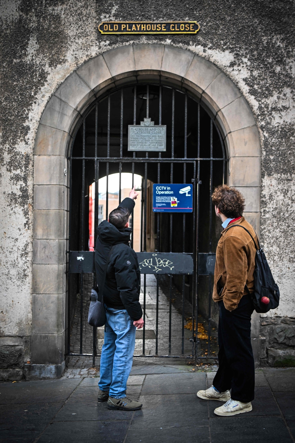 Invisible Cities guide Sonny Murray leads a walking tour with student Arthur Lyhne-Gold, in Cannongate Kirk, Edinburgh, November 17, 2024. — AFP pic