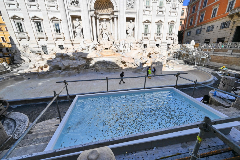 This photograph shows the Trevi Fountain as it undergoes renovation works, with a basin in front to give tourists the chance to throw a coin and make a wish as per tradition. — AFP pic