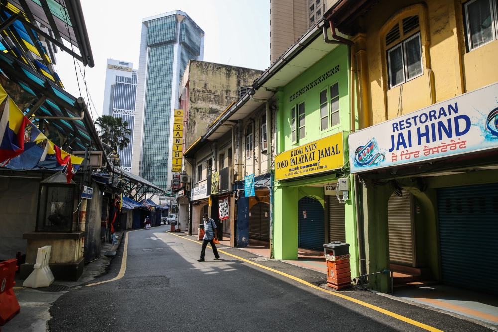 A man walks in front of closed shop in Kuala Lumpur March 21, 2020. — Picture by Yusof Mat Isa