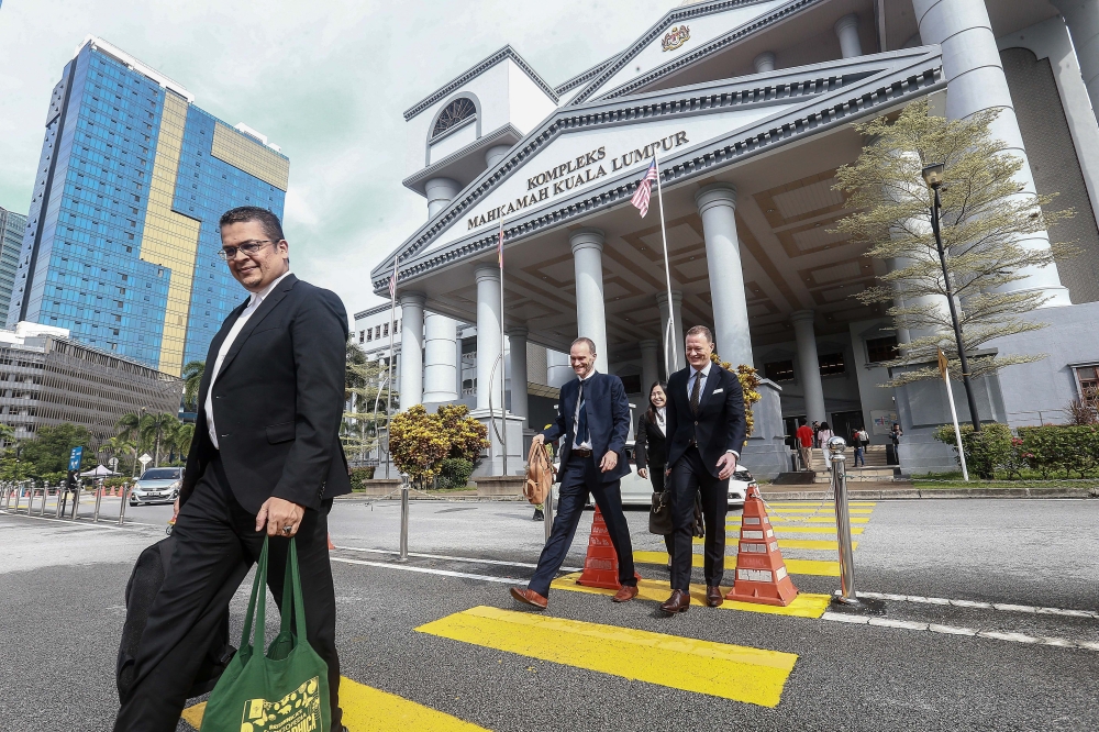 Lawyers Nizam Bashir and Kee Hui Yee with two representatives from Swatch Group are seen here at the Kuala Lumpur court complex after the High Court ordered the return of all seized Pride watches. November 25, 2024. — Picture by Sayuti Zainudin 