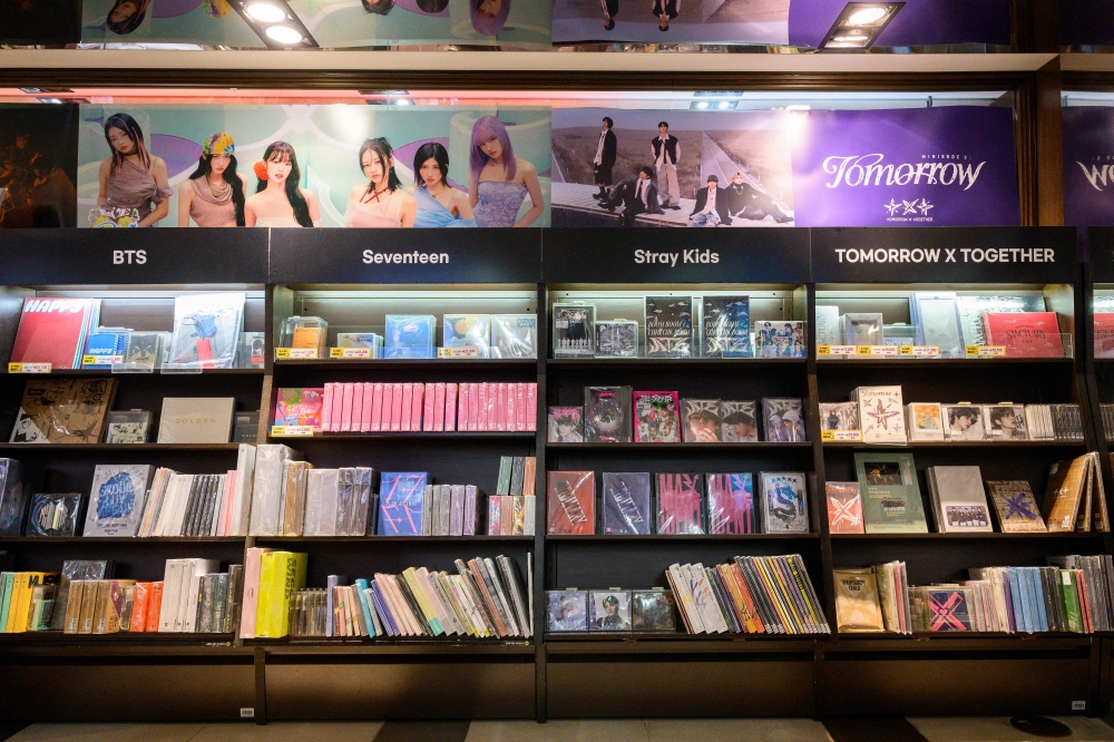 In this photo taken on November 22, 2024, music albums and related merchandise released by K-pop groups and members of BTS, Seventeen, Stray Kids and Tomorrow X Together (TXT) are seen on display in a retail store in Seoul. — AFP pic