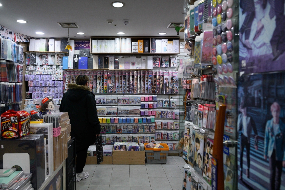 In this photo taken on November 22, 2024, a customer browses a store that sells K-pop related merchandise in a shopping mall in Seoul. — AFP pic