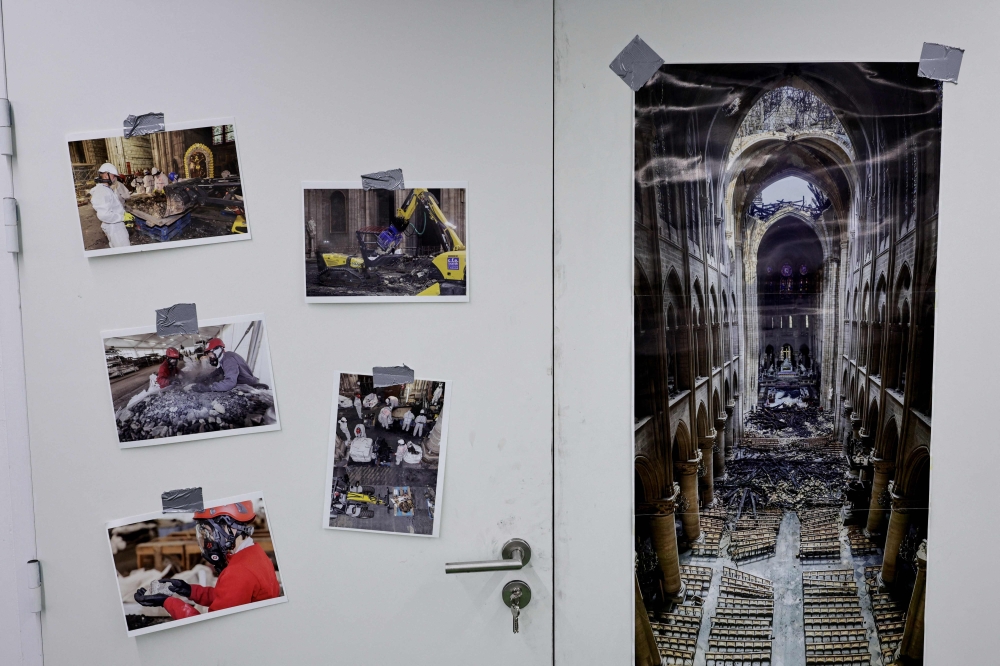 Photographs taken at the Notre Dame de Paris Cathedrale after the fire are displayed in a secret warehouse where archaeological remains of the Cathedral are stored in Paris' region on November 21, 2024. — AFP pic