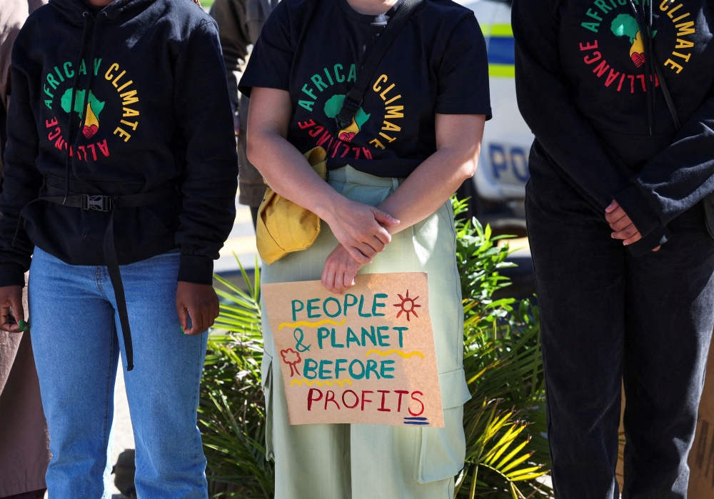 Climate activists demonstrate against oil and gas corporations and to end fossil fuels outside the Cape Town International Convention Centre during the Southern Africa Oil and Gas Conference on September 13, 2023. — Reuters pic