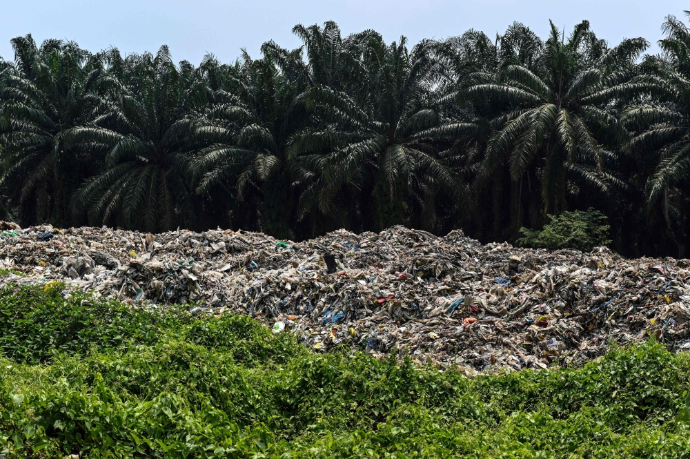 Plastic waste piles up near palm oil trees at an abandoned factory in Jenjarom in Selangor on March 8, 2019. Malaysia has been upping its campaign to reduce single-up plastics, but according to KRI’s report, more needs to be done at a faster pace to save the planet. — AFP pic