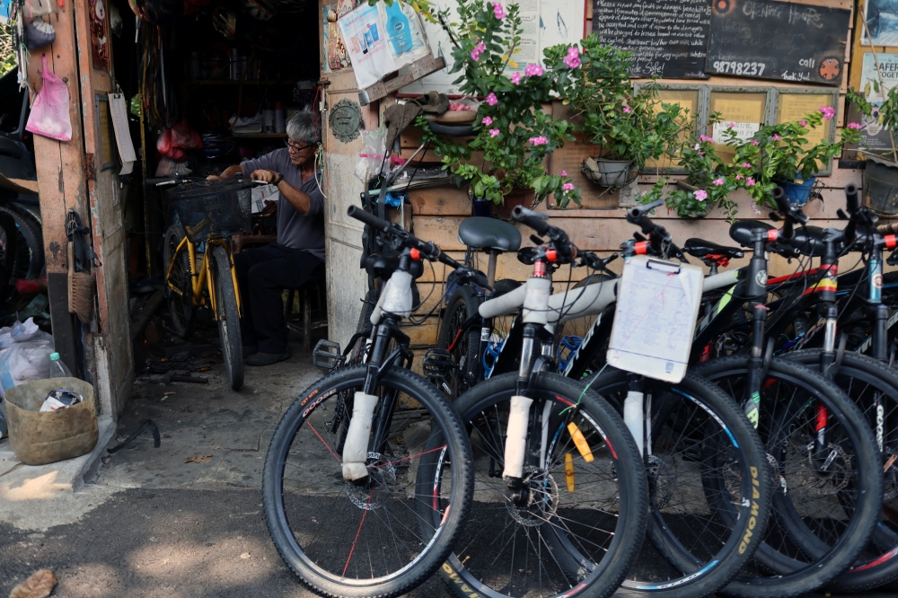 Lim Cyse See, 60, repairs bicycles in his shop on Singapore’s Pulau Ubin island November 1, 2024. — Reuters pic