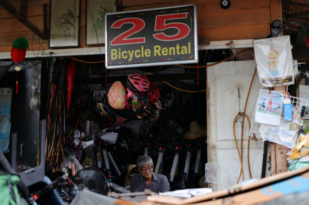 Lim Cyse See, 60, sits in his bike repair shop on Singapore’s Pulau Ubin island November 1, 2024. — Reuters pic