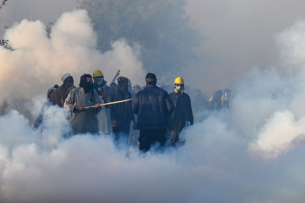 Policemen fire tear gas shells to disperse supporters of Pakistan Tehreek-e-Insaf (PTI) party during a protest to demand the release of former prime minister Imran Khan, in Islamabad on November 26, 2024. — AFP pic