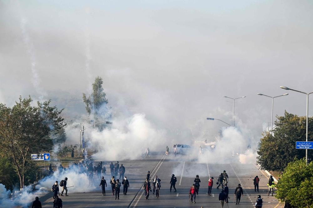 Policemen fire tear gas shells to disperse supporters of Pakistan Tehreek-e-Insaf (PTI) party during a protest to demand the release of former prime minister Imran Khan, in Islamabad on November 26, 2024. — AFP pic