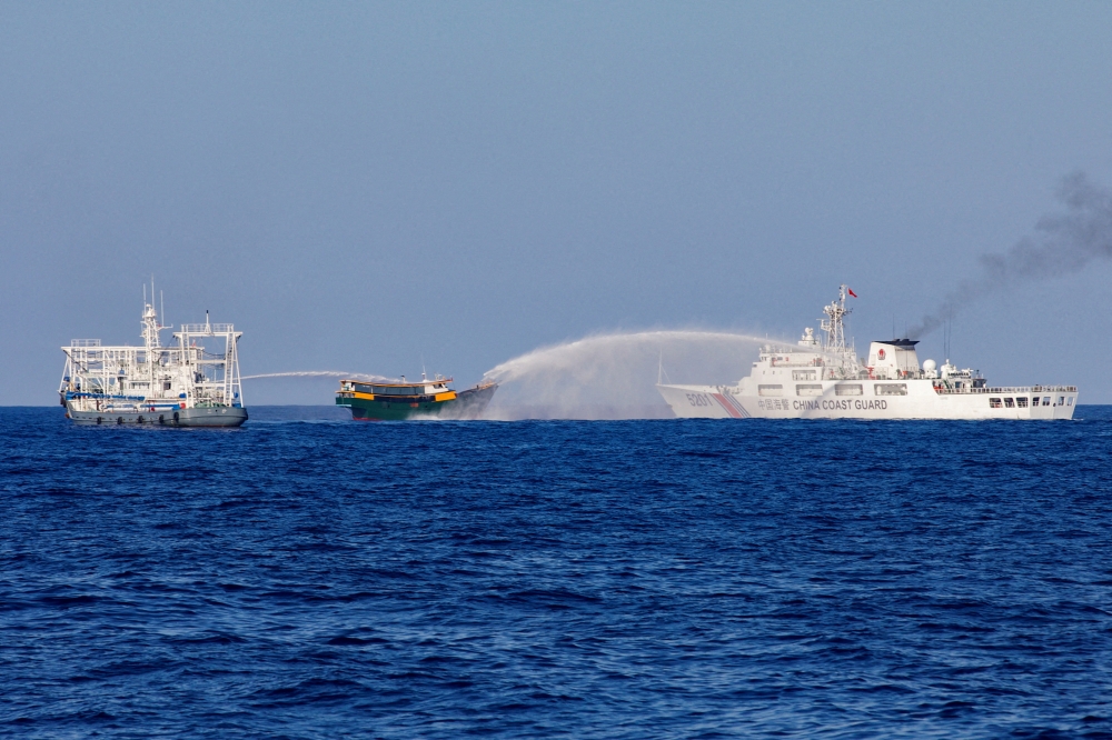 Violent confrontations between Chinese and Philippine vessels in the South China Sea are being manipulated online by disinformation networks for profit, posing risks to regional security, an AFP investigation has found. — Reuters pic