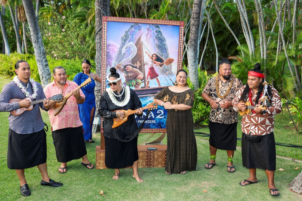 Polynesian musicians play near the movie poster of Moana 2 during the premiere of Disney Animation’s film Moana 2 in Kapolei, Hawaii November 21, 2024. — Reuters pic  