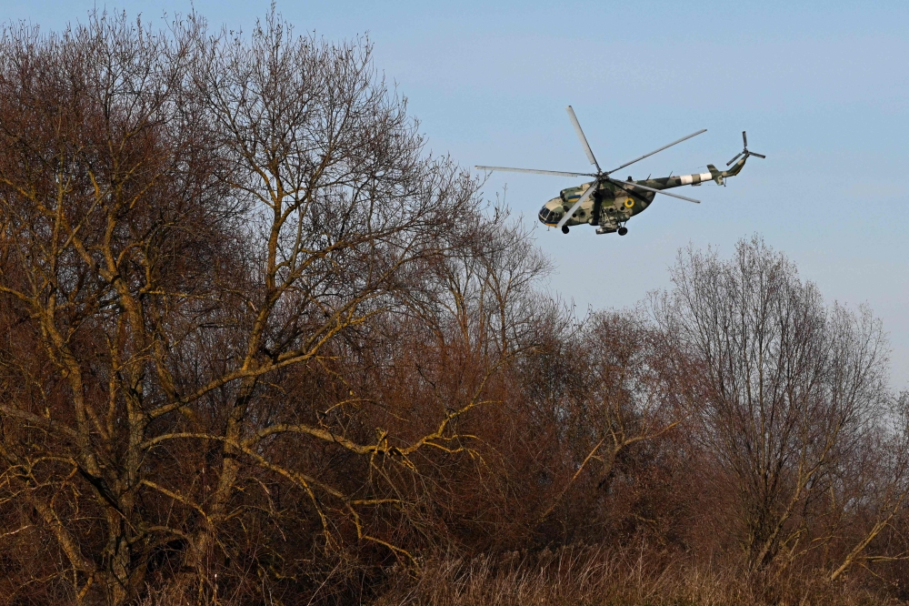 A Mi-8 military helicopter flies at low altitude during a training flight at an undisclosed location in Lviv region on November 7, 2024, amid the Russian invasion of Ukraine. — AFP pic