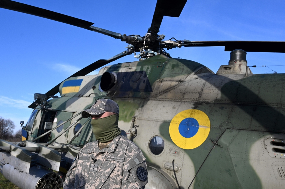 Commander Andriy stands next to a Mi-8 military helicopter during a training at an undisclosed location in Lviv region on November 7, 2024, amid the Russian invasion of Ukraine. — AFP pic