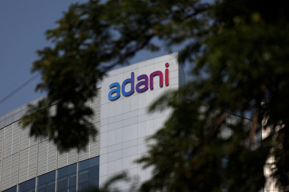 The logo of the Adani Group is seen on the facade of its Corporate House on the outskirts of Ahmedabad November 21, 2024. — Reuters pic  